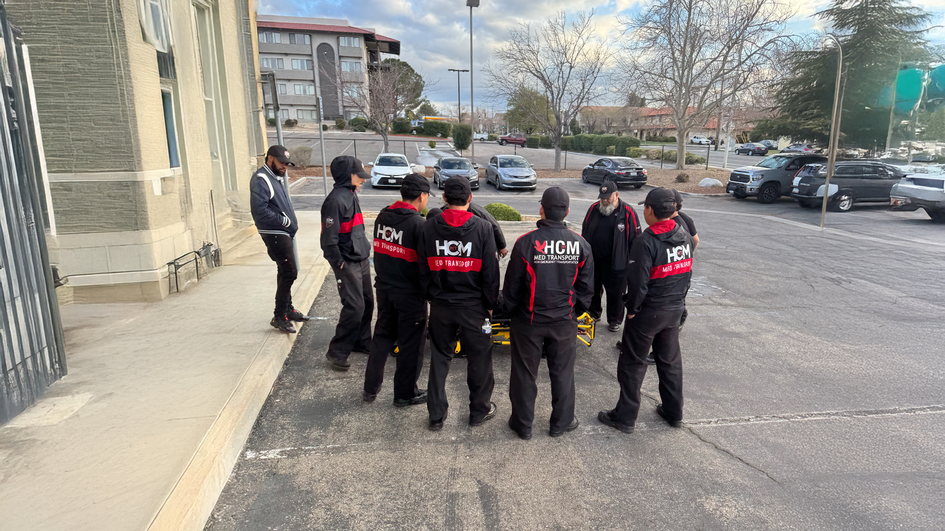 HCM crew members in uniform gathered outside the Lancaster office before shift.